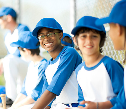 Boys wearing baseball team dress with a cap at YMCA Greater Charlotte
