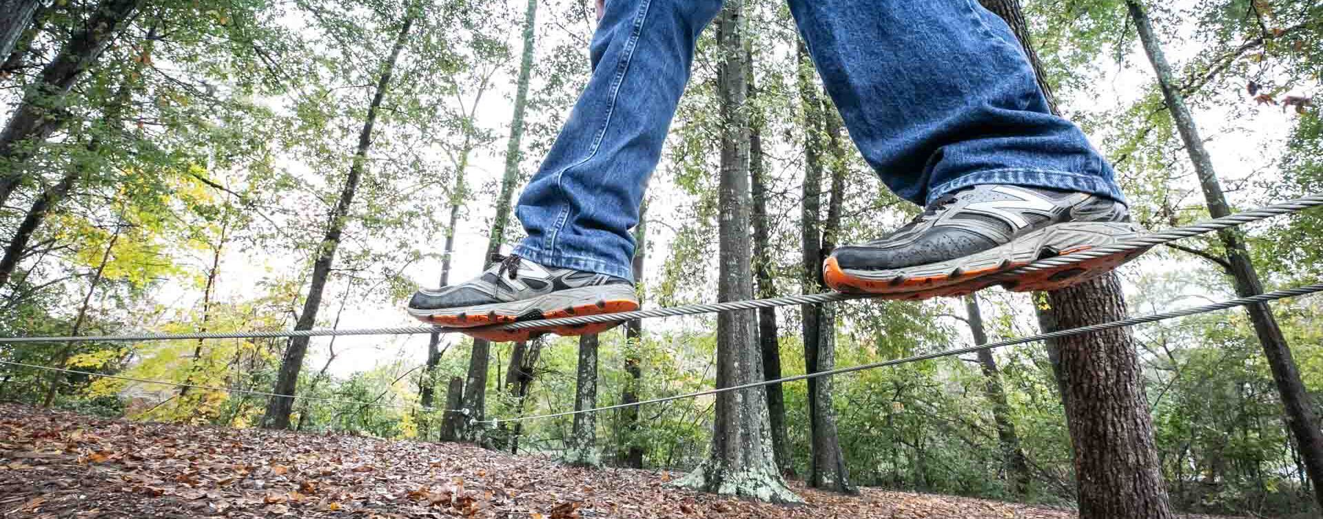 Pair of legs walking on a rope at the YMCA outdoor activities